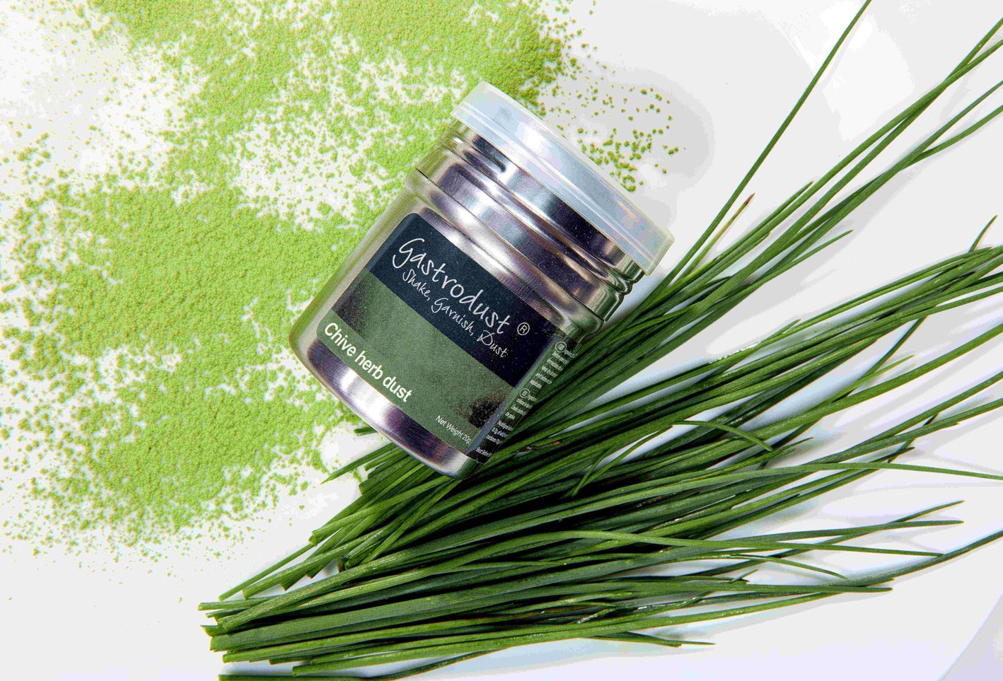 tub of chive gastrodust with sprigs of chive